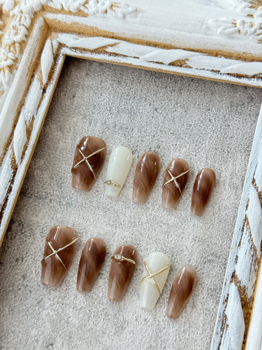 Long hand-painted marble nails brown