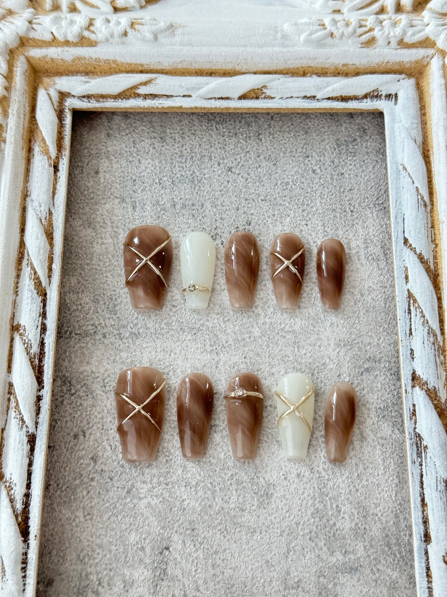 Long hand-painted marble nails brown